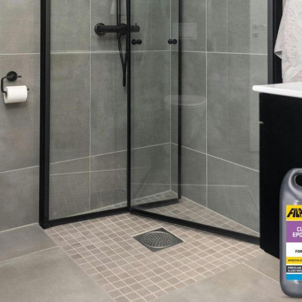 Cloudy epoxy grout haze being cleaned from porcelain tiles with Fila CR10
