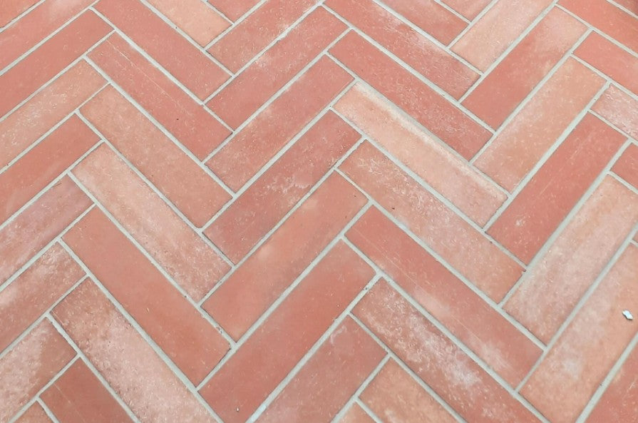 Sealed terracotta tile floor with a warm natural finish